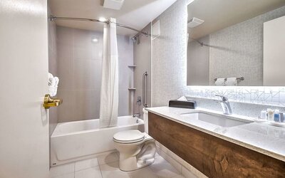 Guest bathroom with shower at Comfort Inn And Suites Calgary South.