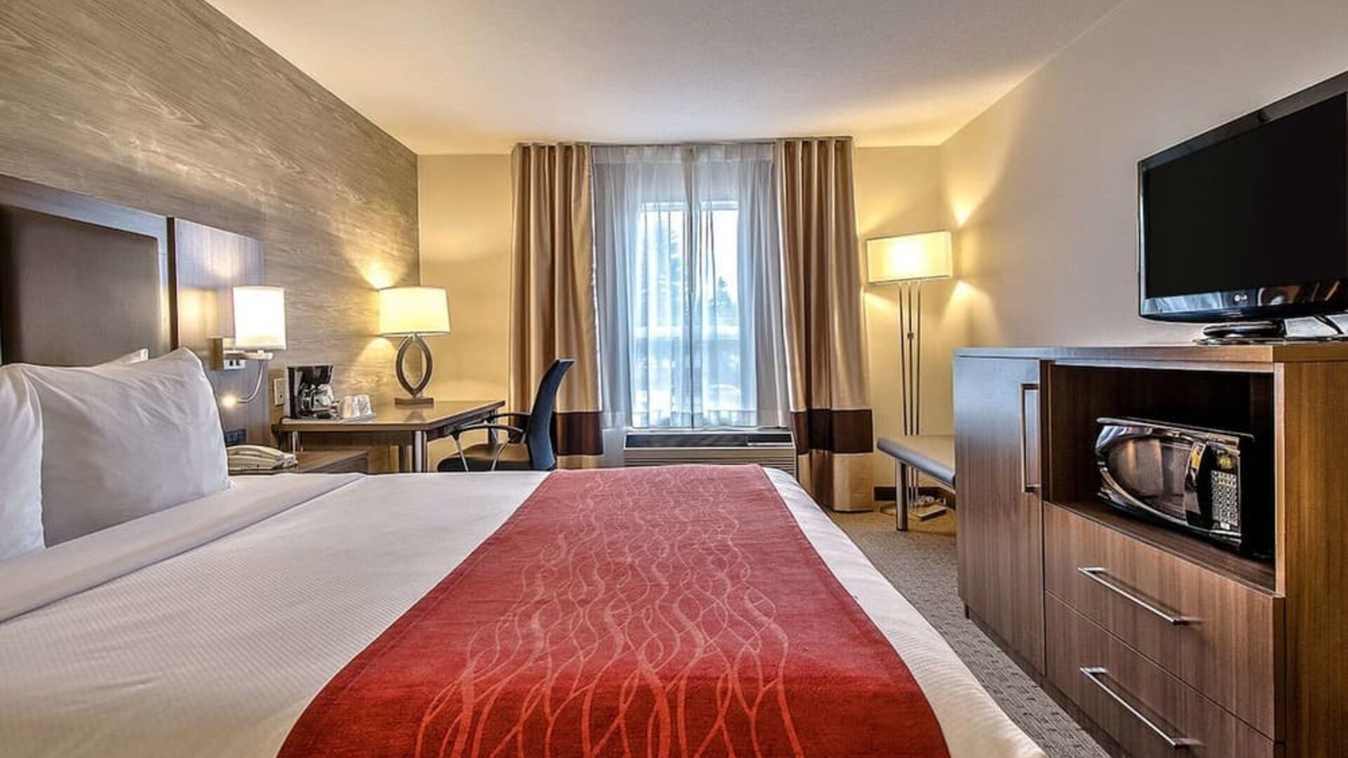 King room with TV and work desk at Comfort Inn And Suites Calgary South.