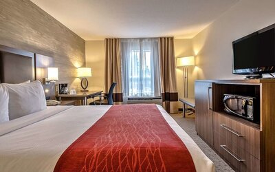 King room with TV and work desk at Comfort Inn And Suites Calgary South.