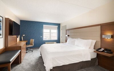 King guest room featuring premium bedding, ergonomic workspace, and thoughtfully designed amenities at Holiday Inn Express & Suites Boston-Cambridge.