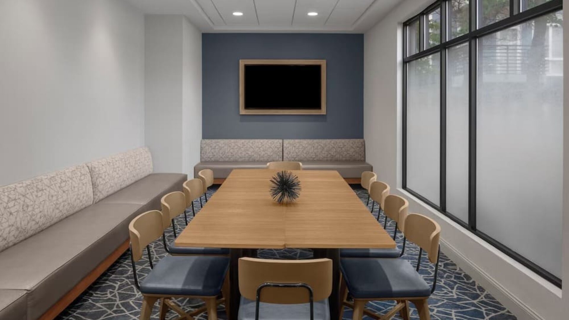 Flexible meeting room equipped for business meetings, presentations, and small group gatherings at Holiday Inn Express & Suites Boston-Cambridge.