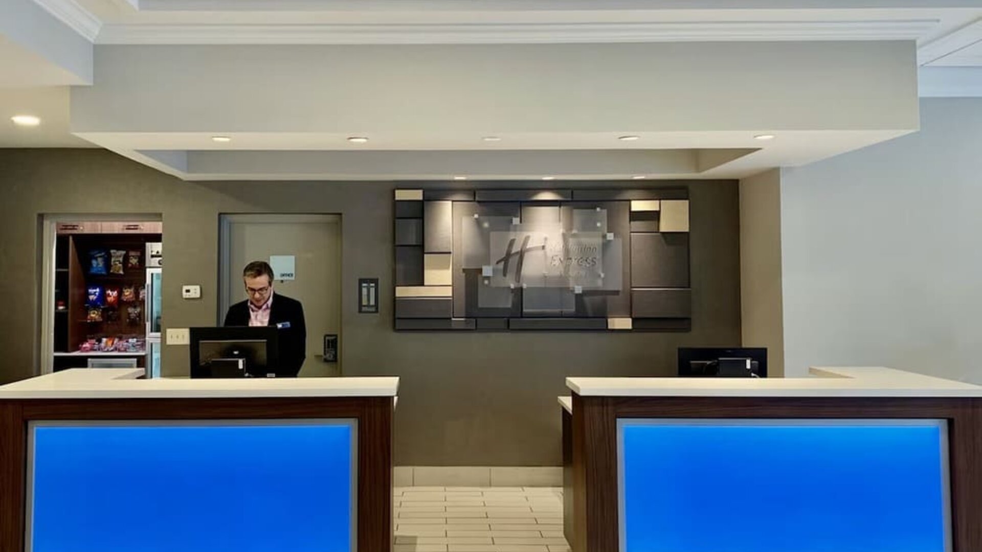 Modern reception area with welcoming front desk service and contemporary design at Holiday Inn Express & Suites Boston-Cambridge.