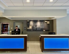 Modern reception area with welcoming front desk service and contemporary design at Holiday Inn Express & Suites Boston-Cambridge.
