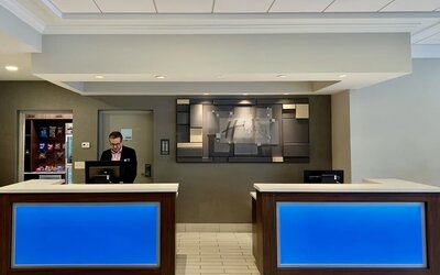 Modern reception area with welcoming front desk service and contemporary design at Holiday Inn Express & Suites Boston-Cambridge.