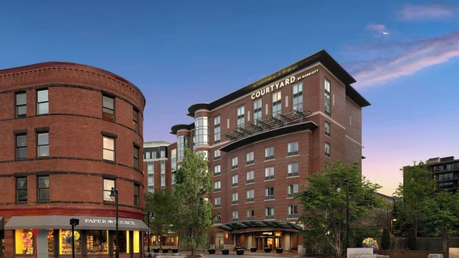 Exterior view showcasing the modern brick architecture and prime location of Courtyard by Marriott Boston Brookline.