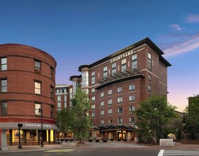 Exterior view showcasing the modern brick architecture and prime location of Courtyard by Marriott Boston Brookline.