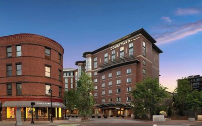 Exterior view showcasing the modern brick architecture and prime location of Courtyard by Marriott Boston Brookline.