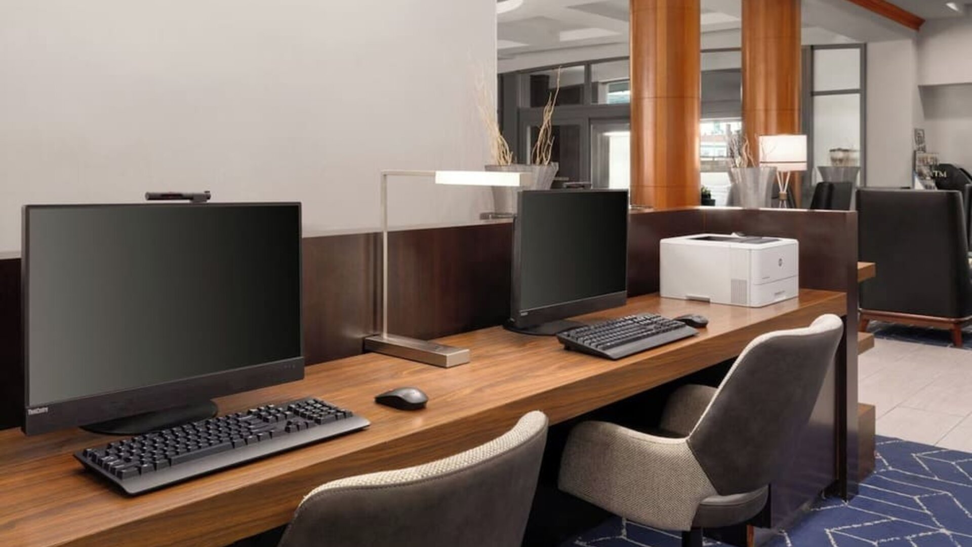 Business center featuring computer workstations and printing capabilities for guest productivity and convenience at Courtyard by Marriott Boston Brookline.
