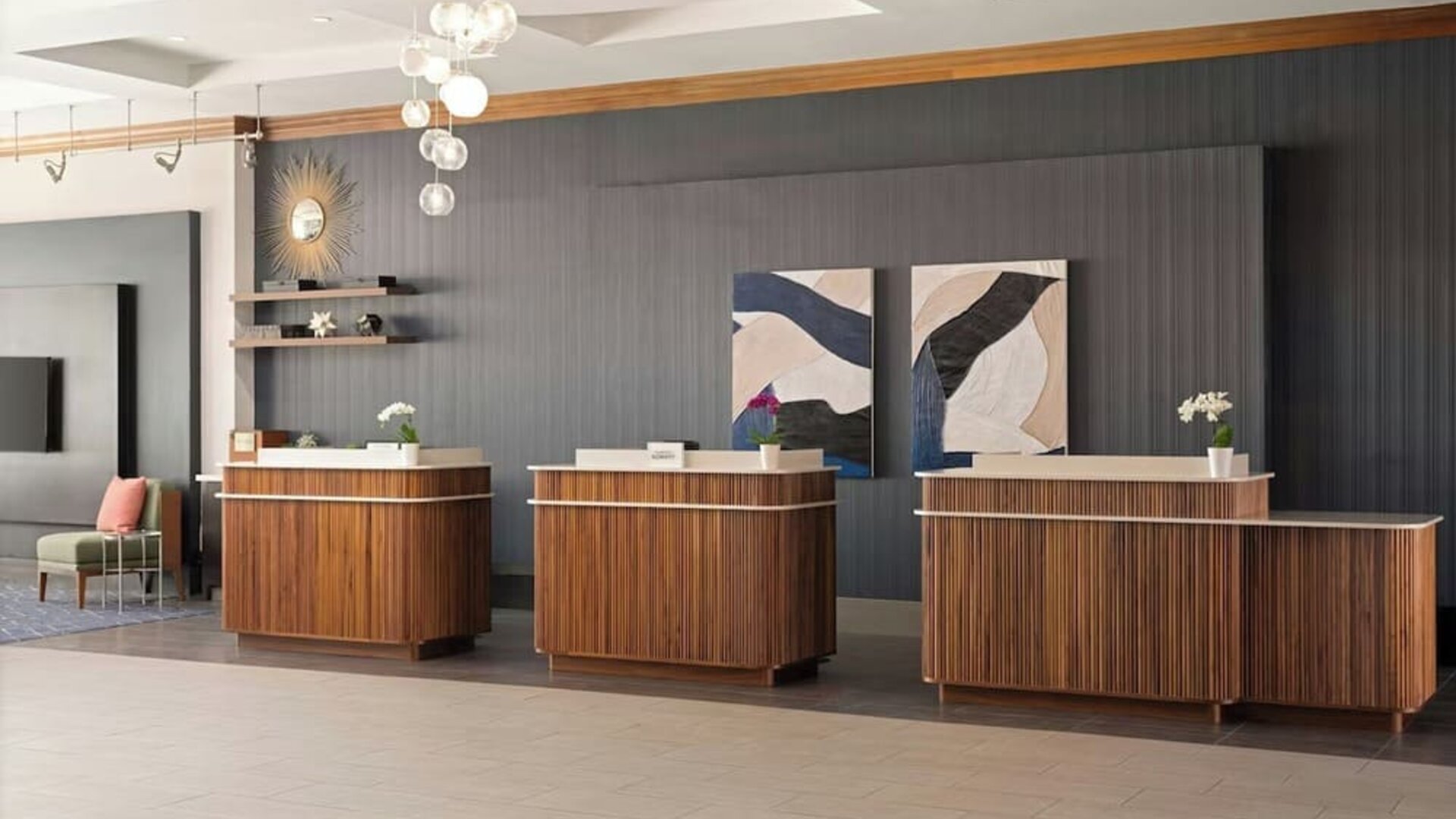 Contemporary reception desk providing efficient check-in services and a welcoming arrival experience at Courtyard by Marriott Boston Brookline.