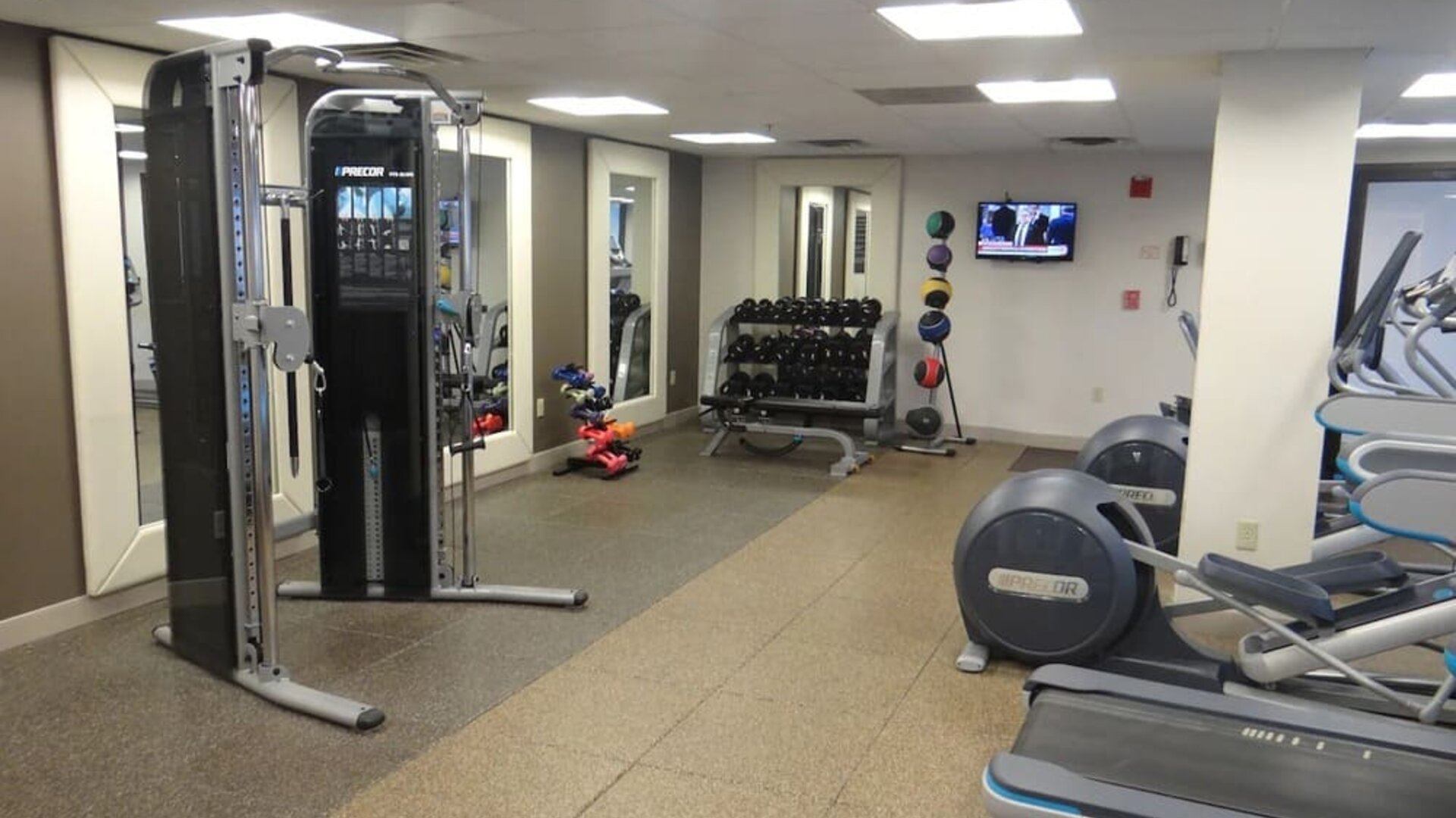 Fitness center equipped with cardio machines, free weights, and strength-training equipment to support guests’ wellness routines at DoubleTree by Hilton Westborough.