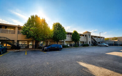 Exterior view of the hotel showcasing convenient parking, easy room access, and a welcoming setting for travelers visiting Wichita at Blue Way Inn & Suites Wichita East.