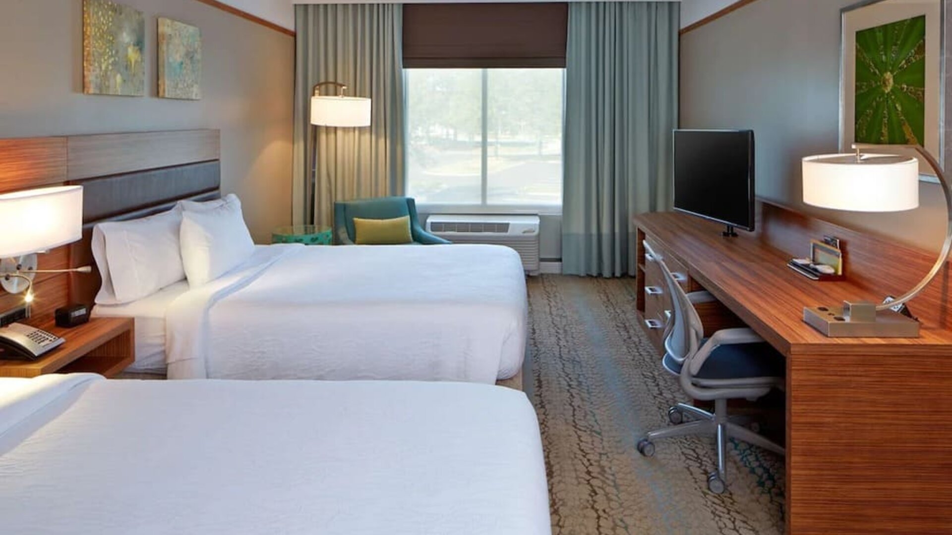 Guest room with two comfortable beds, spacious work area, and modern amenities designed for families, groups, and business travelers at Hilton Garden Inn Boston/Marlborough.