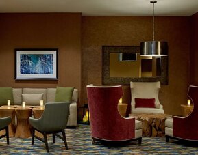 Inviting lounge area featuring comfortable seating, warm décor, and intimate gathering spaces perfect for relaxing or meeting with colleagues at Hilton Garden Inn Boston/Marlborough.