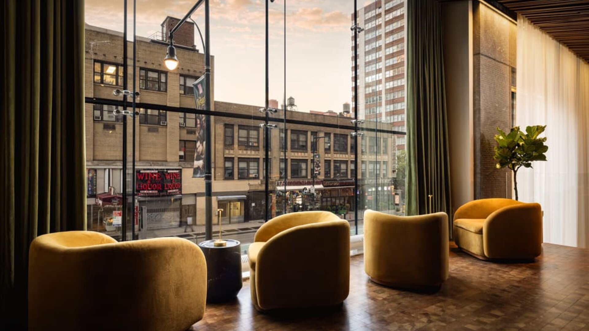 Window-side lounge seating featuring city views, comfortable furnishings, and a relaxing atmosphere in the heart of Row NYC.