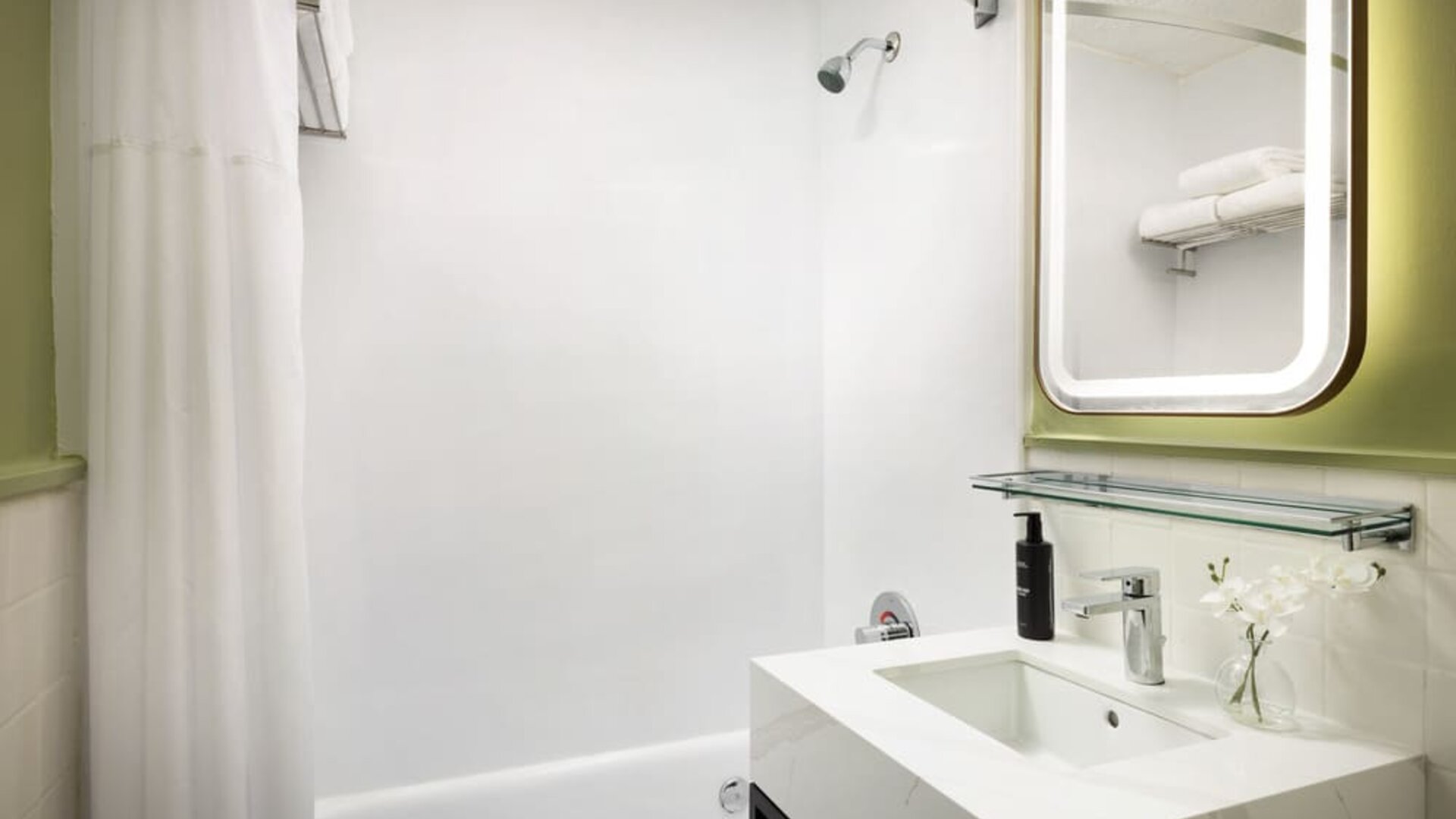 Bright and functional bathroom featuring a full-size bathtub, modern fixtures, and fresh amenities for a comfortable stay at Row NYC.