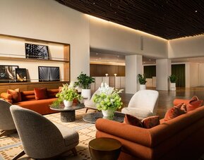 Inviting lounge area featuring contemporary furnishings, warm décor, and comfortable seating spaces for relaxation and socializing at Row NYC.