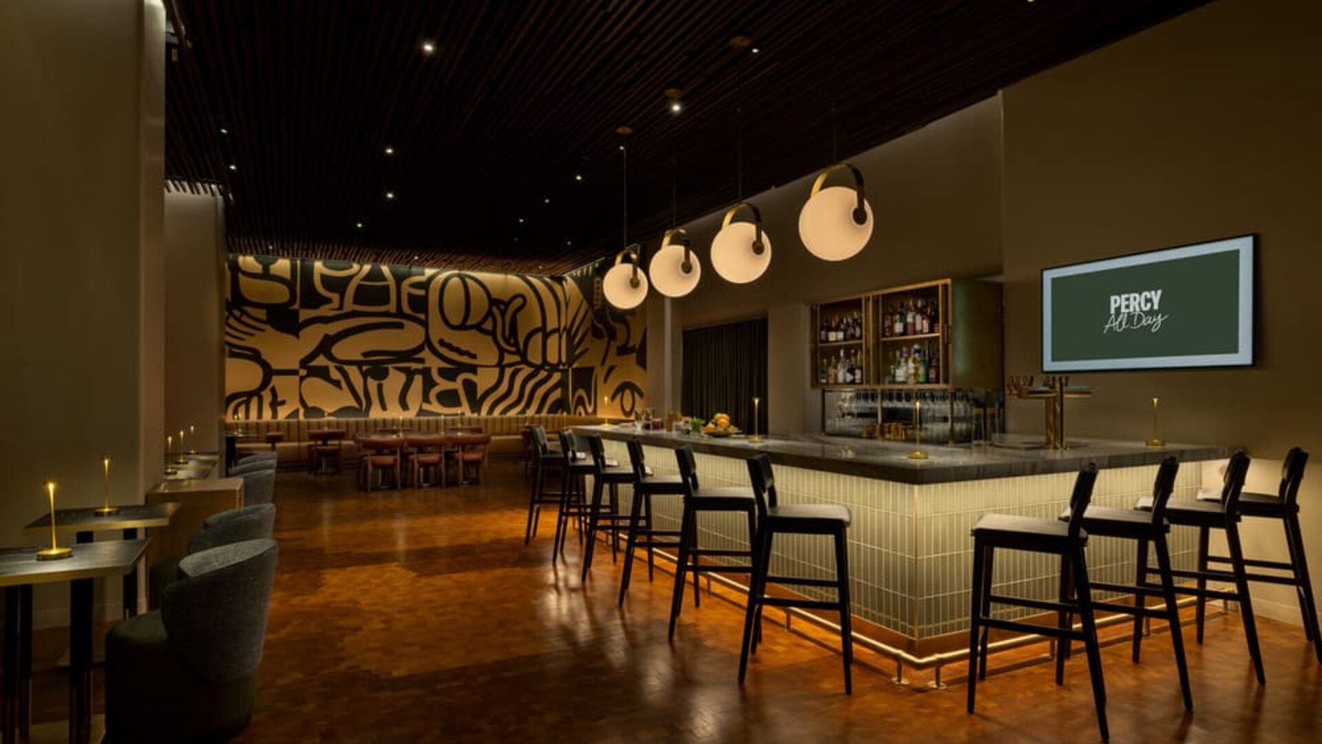 Modern hotel bar featuring stylish seating, premium beverage selections, and an energetic atmosphere perfect for evening gatherings at Row NYC.