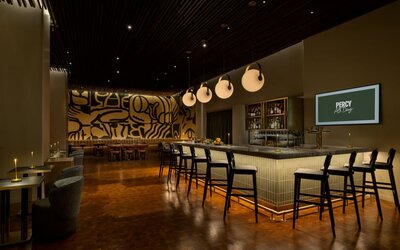 Modern hotel bar featuring stylish seating, premium beverage selections, and an energetic atmosphere perfect for evening gatherings at Row NYC.