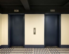 Elevator lobby featuring convenient guest access, modern finishes, and efficient transportation throughout Row NYC.