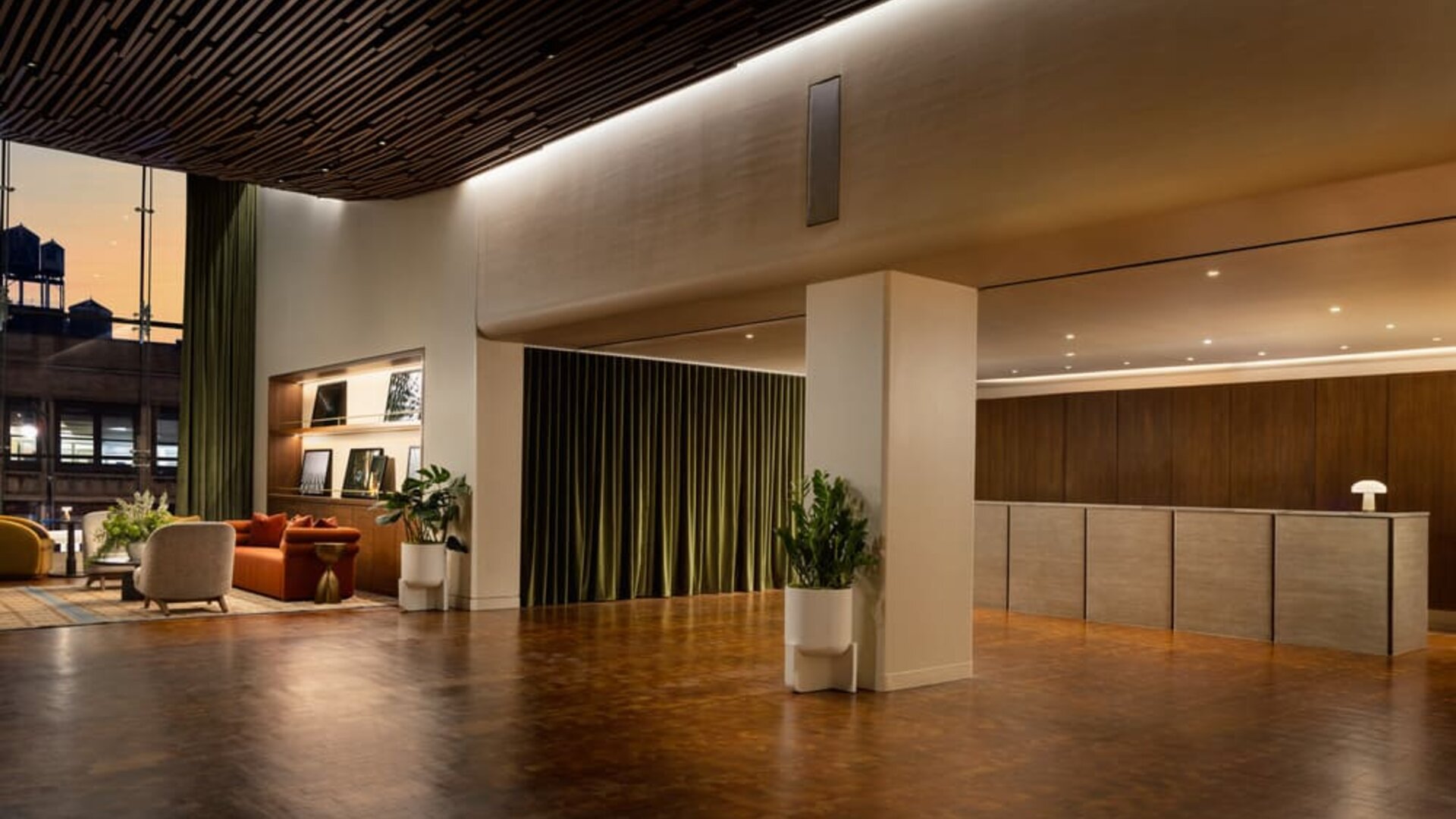 Spacious hotel reception area featuring modern design, streamlined check-in services, and a welcoming atmosphere for arriving guests at Row NYC.