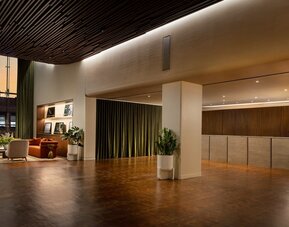 Spacious hotel reception area featuring modern design, streamlined check-in services, and a welcoming atmosphere for arriving guests at Row NYC.