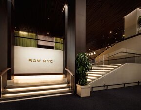 Interior stairway showcasing modern design, illuminated steps, and sophisticated architectural details within Row NYC.