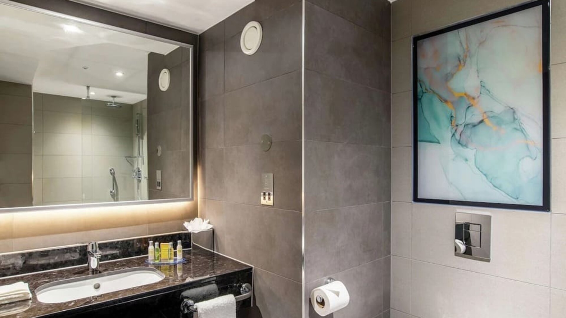 Guest bathroom with shower at Hilton Garden Inn London Heathrow Terminals 2 And 3.