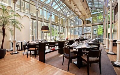 Dining area with natural light at Hilton London Euston.