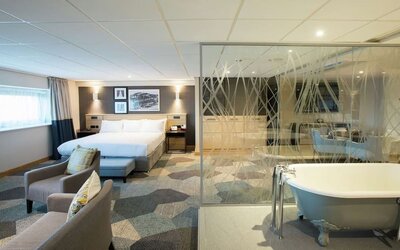 Spacious day use room with living area and tub at DoubleTree By Hilton Coventry Building Society Arena.