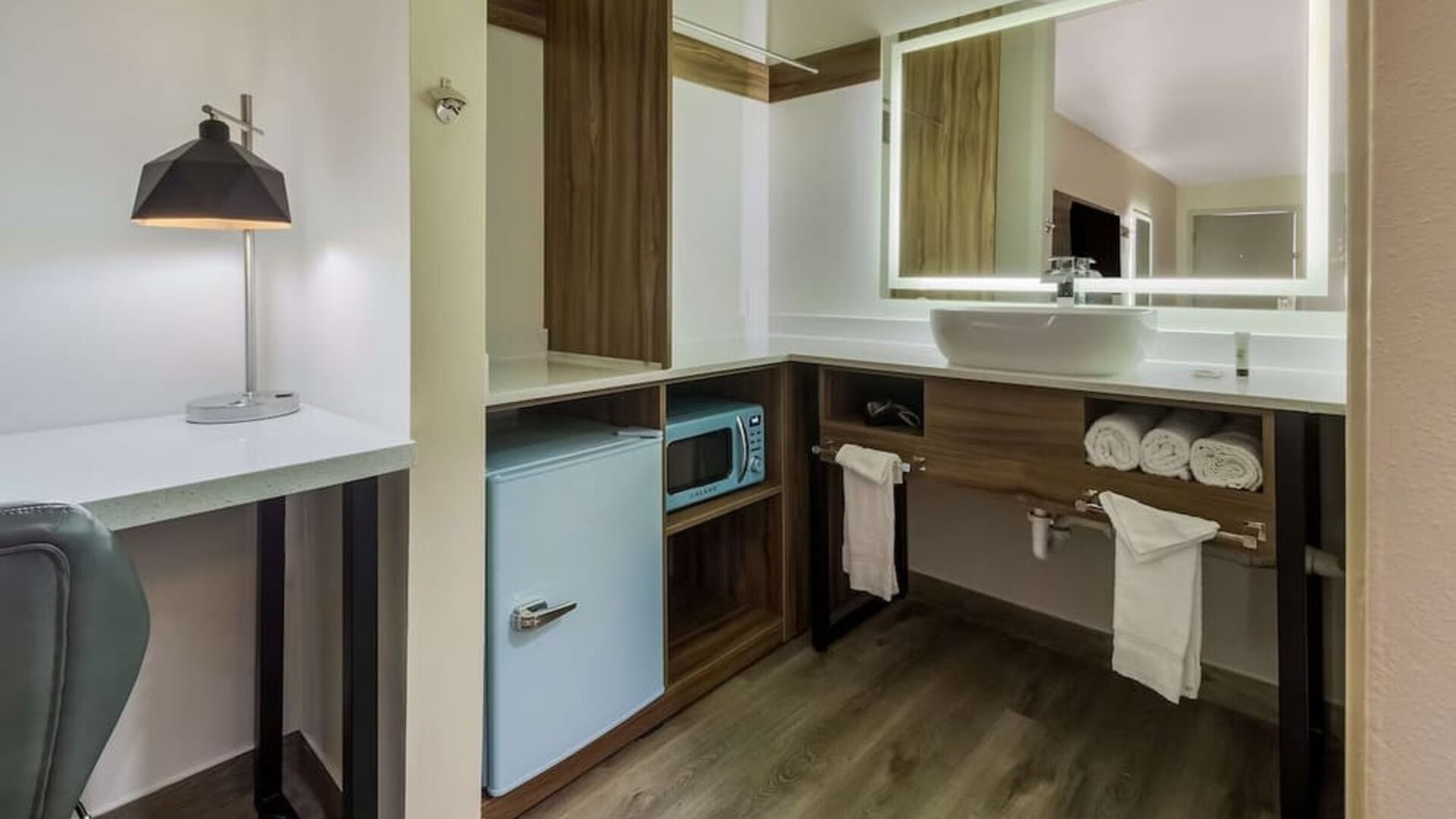 Day use room with mini-fridge and private bathroom at Signature Inn Houston Galleria.