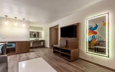 Spacious day room with TV at Signature Inn Houston Galleria.