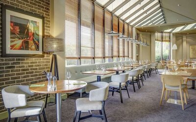 Spacious dining room with natural light at DoubleTree By Hilton Manchester Airport.