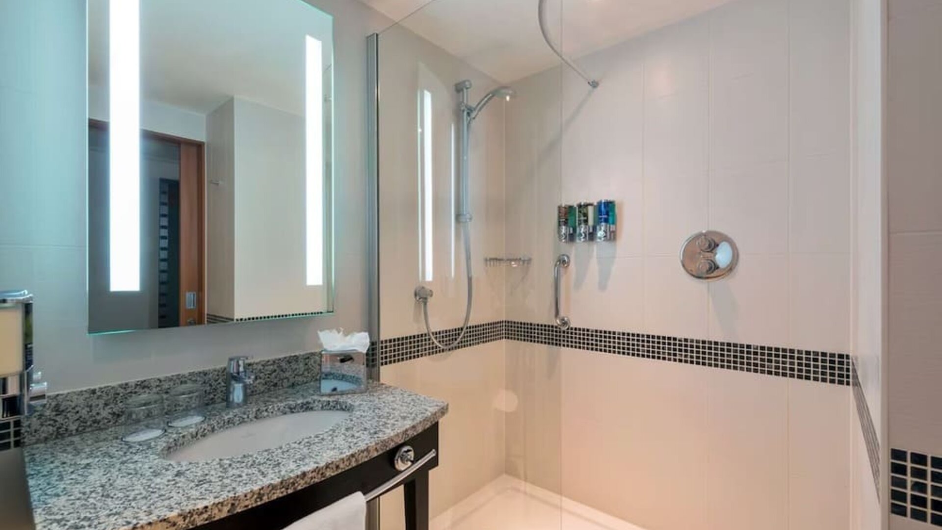 Guest bathroom with shower at Hampton By Hilton London Luton Airport.