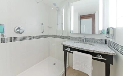 Private bathroom with shower and bath at Hampton By Hilton London Gatwick Airport.