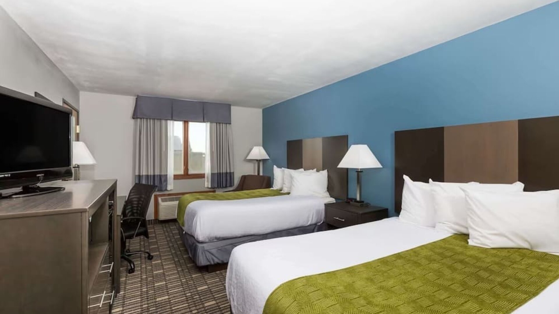 Day room with two queen beds at Baymont By Wyndham Pella.