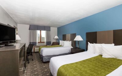 Day room with two queen beds at Baymont By Wyndham Pella.