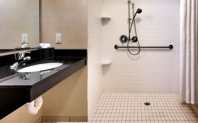Guest bathroom with shower at Fairfield Inn & Suites By Marriott Tallahassee Central.