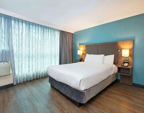 Romantic king room with natural light at Grand Park Hotel & Suites Downtown Vancouver.