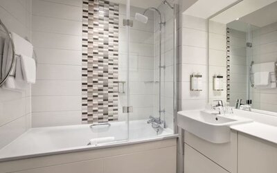 Guest bathroom with shower and tub at Leonardo Hotel Chester.