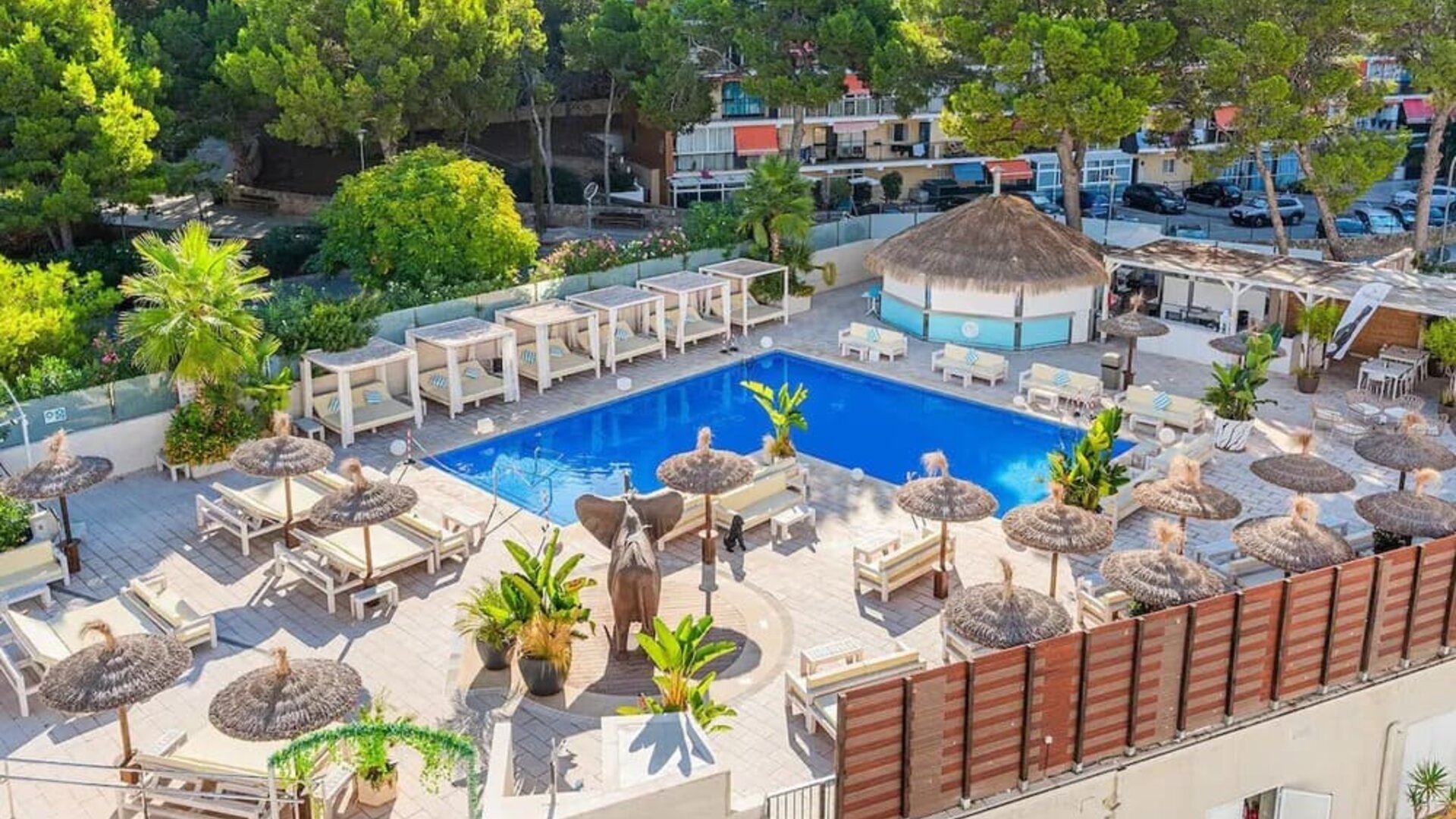 Outdoor pool with loungers at INN Mallorca Aparthotel.