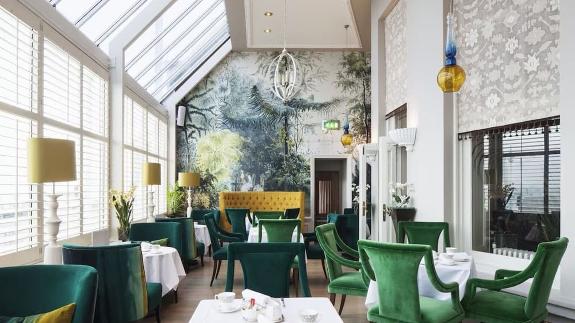 Modern dining area with high ceiling and natural light at The Grand Brighton.