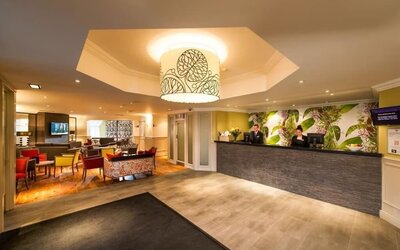 Reception and coworking lounge at Leonardo Inn Glasgow West End. 