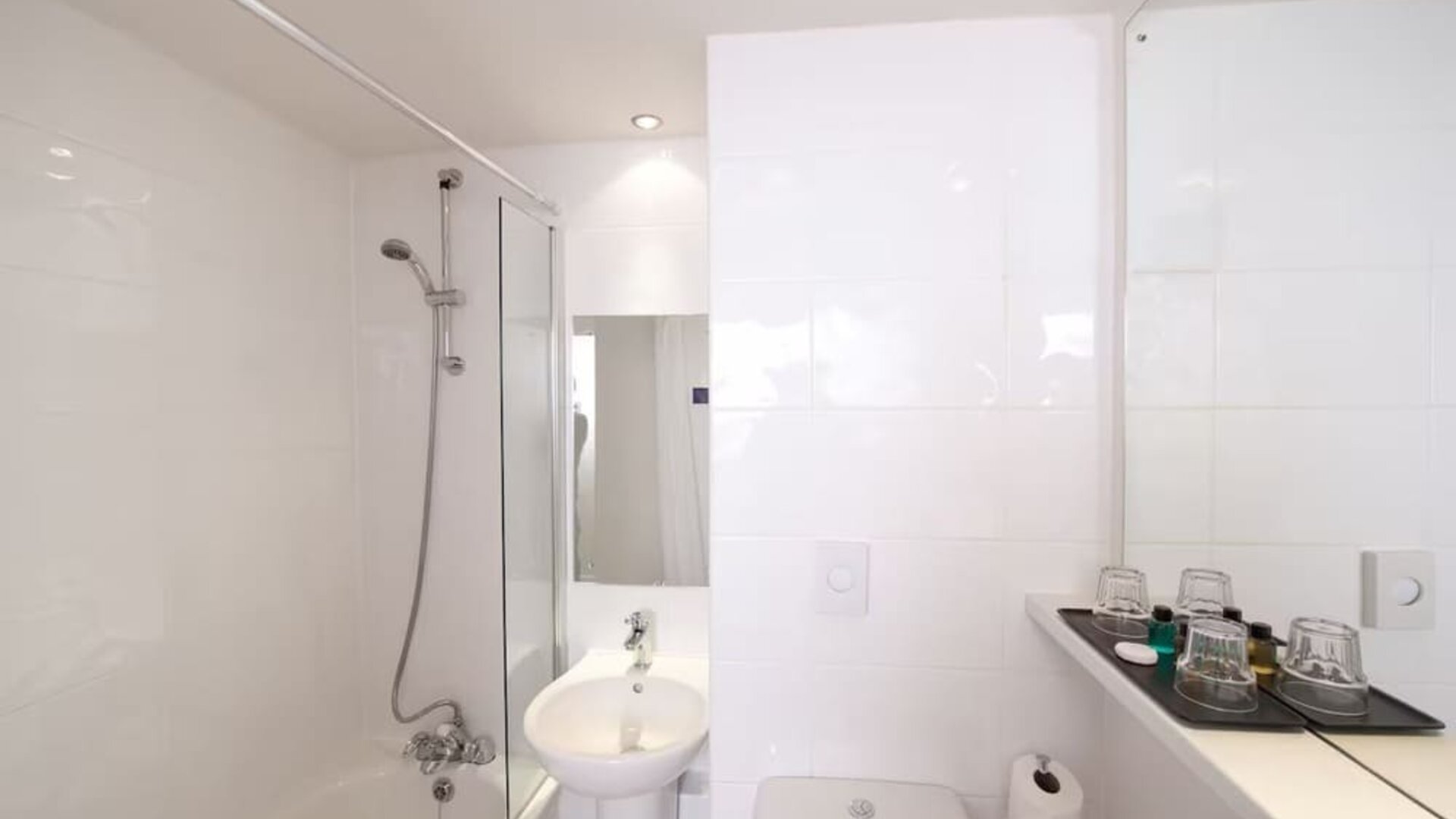 Guest bathroom with shower at Leonardo Inn Glasgow West End. 