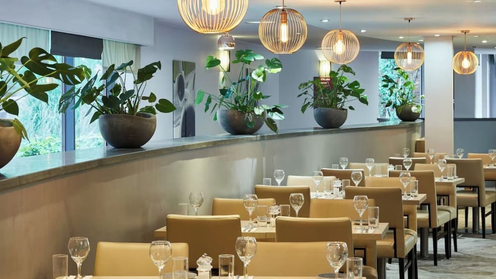 Dining area perfect for coworking at Leonardo Hotel London Heathrow Airport.