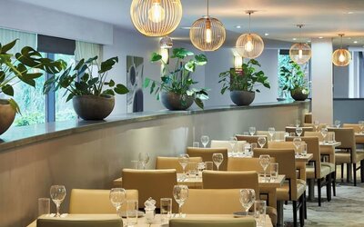 Dining area perfect for coworking at Leonardo Hotel London Heathrow Airport.