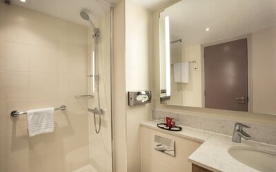 Guest bathroom with shower at Leonardo Hotel London Heathrow Airport.