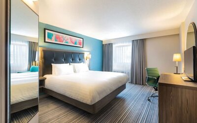 Day use room with tv and work desk at Leonardo Hotel Plymouth. 