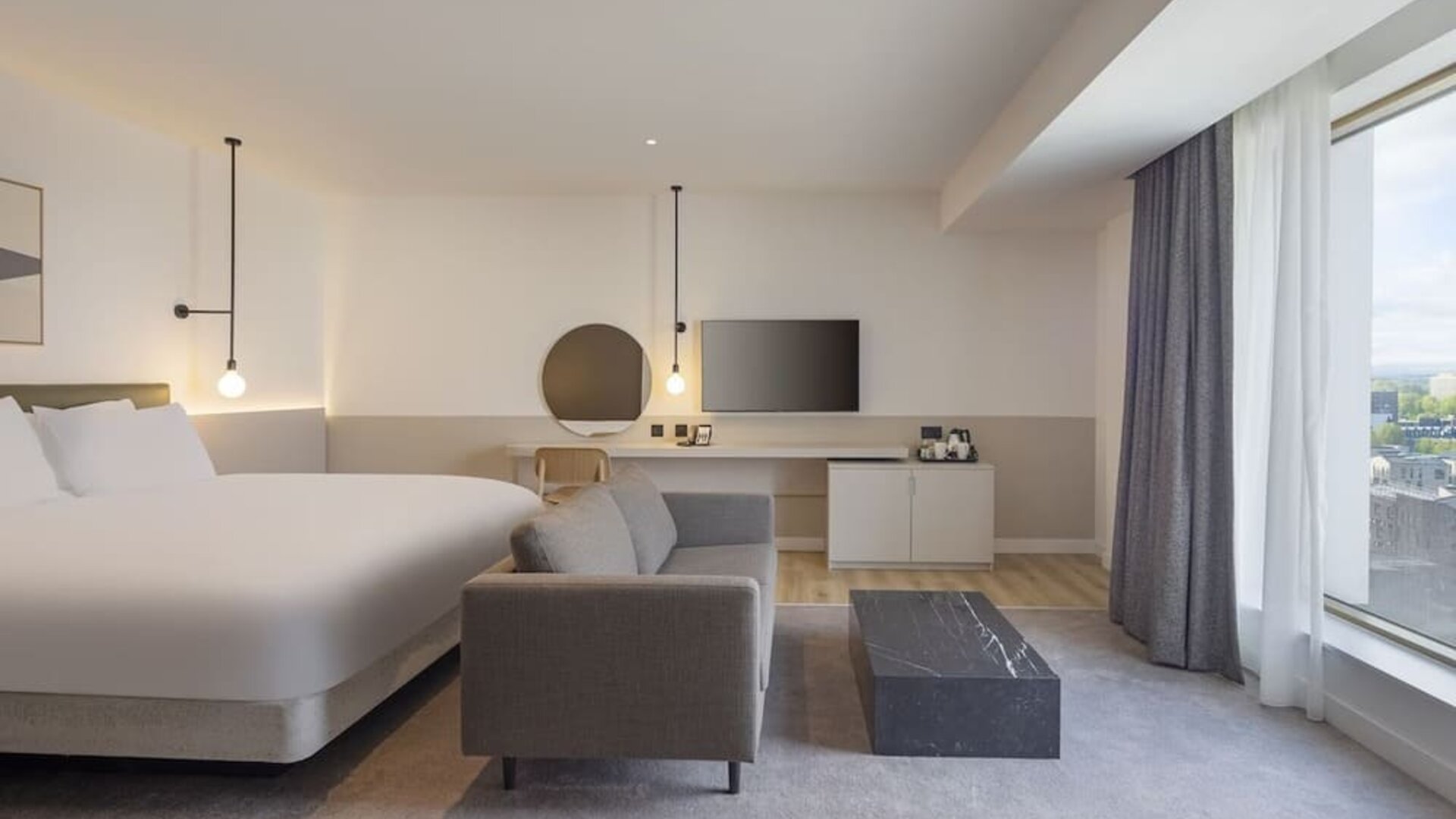 Spacious day use room with sofa at Leonardo Hotel Manchester Piccadilly. 