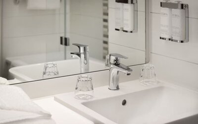 Guest bathroom with shower at Leonardo Hotel Manchester Piccadilly. 