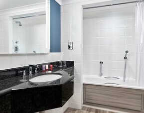 Guest bathroom with shower and tub at Leonardo Hotel Southampton Grand Harbour.